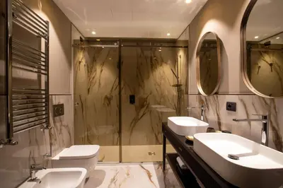 a bathroom with two sinks and a shower at Condotti Boutique Hotel in Rome