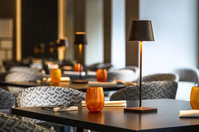 a group of tables with chairs and a lamp at Hotel Delle Nazioni in Rome