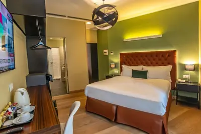 a bedroom with a large bed and a television at Hotel Elite in Rome