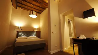 a bedroom with a bed and a television in a room at Hotel Elite in Rome