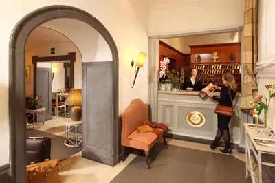 a woman standing at a counter in a salon at Hotel Villa Glori in Rome