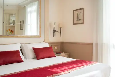 a bedroom with a bed with two red pillows at Hotel Villa Glori in Rome