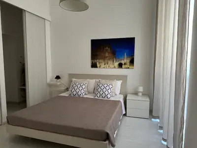 a bedroom with a bed and a painting on the wall at Rome Holiday Home in Rome