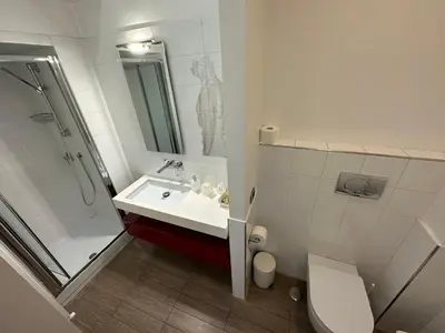 a bathroom with a sink and a shower and a toilet at Rome Holiday Home in Rome