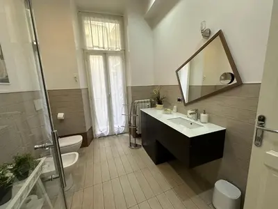 a bathroom with a sink and a toilet and a mirror at Rome Holiday Home in Rome