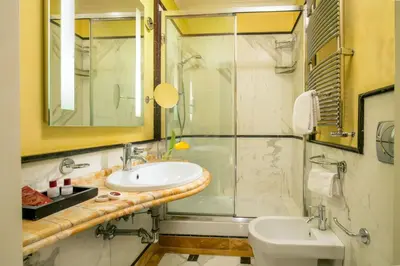 a bathroom with a sink and a shower and a toilet at Suite Opera Rooms in Rome