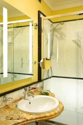 a bathroom with a sink and a glass shower at Suite Opera Rooms in Rome