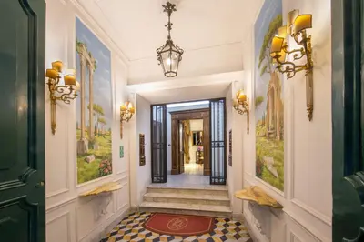 a hallway with a door and a rug on the floor at Suite Opera Rooms in Rome