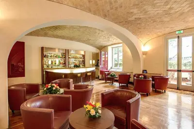 a restaurant with chairs and tables and a bar at Kolbe Hotel Rome in Rome