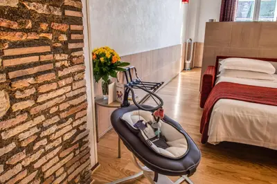 a hospital room with a baby chair and a bed at Kolbe Hotel Rome in Rome