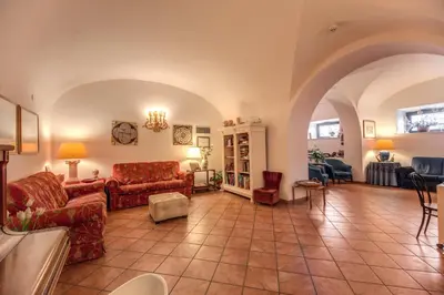 a living room with two couches and a table at Hotel Corona in Rome