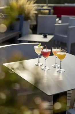 three cocktails sitting on top of a table at Hotel San Francesco in Rome