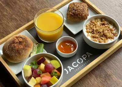 a tray with a tray of breakfast foods and a drink at Hotel San Francesco in Rome
