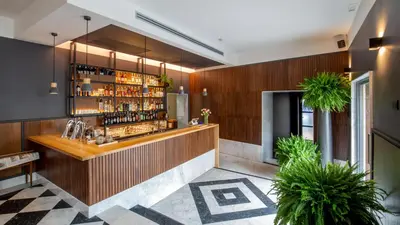 a bar in a restaurant with wooden walls at Hotel San Francesco in Rome