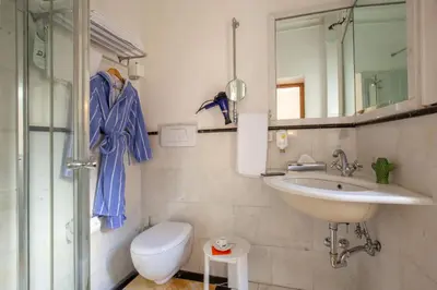 a bathroom with a sink and a toilet and a mirror at Hotel Emona Aquaeductus in Rome