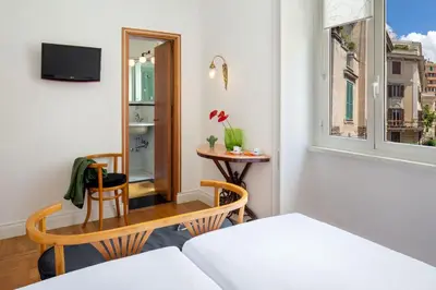 a small room with a table and a mirror at Hotel Emona Aquaeductus in Rome