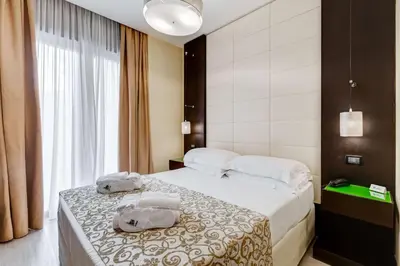 a hotel room with a bed with two towels on it at Best Western Cinemusic Hotel in Rome
