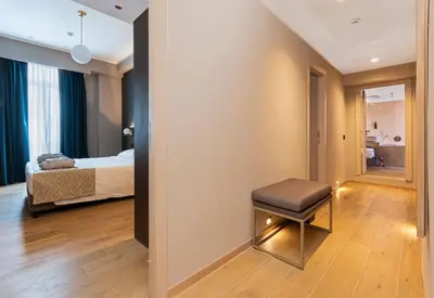 a bedroom with a bed and a stool in a room at Hotel San Remo in Rome