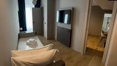 a living room with a couch and a flat screen tv at Hotel San Remo in Rome