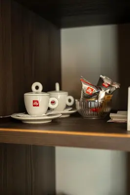 a shelf with two coffee cups and a basket on it at Hotel San Remo in Rome