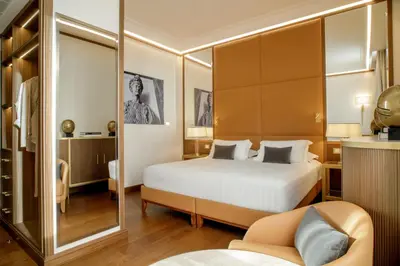 a living room with a couch and a bed at Hotel Imperiale by OMNIA hotels in Rome