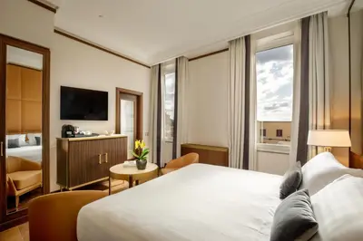 a hotel room with a large bed and a television at Hotel Imperiale by OMNIA hotels in Rome