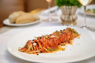 a restaurant with tables with plates of food and wine glasses at Hotel Imperiale by OMNIA hotels in Rome