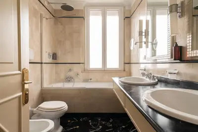 a bathroom with two sinks and a toilet and a tub at Hotel Degli Aranci in Rome