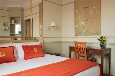 a bedroom with a bed and a desk and a chair at Hotel Degli Aranci in Rome