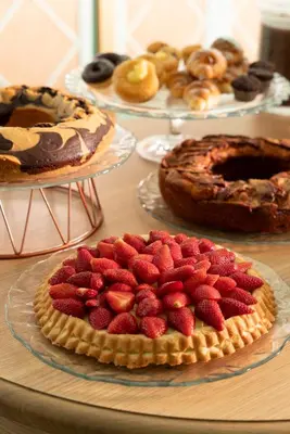 a table topped with pies and strawberries on plates at Hotel Degli Aranci in Rome