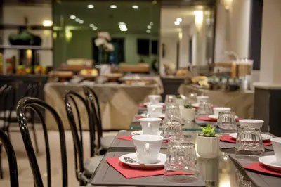 a long table with red napkins and glasses on it at Hotel Buenos Aires in Rome