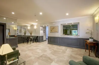 a large living room with a bar and a dining room at Hotel Buenos Aires in Rome