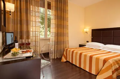 a hotel room with a bed and a tray of food at Hotel Buenos Aires in Rome