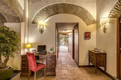 an office with an archway and a desk with a computer at Residenza San Calisto in Rome
