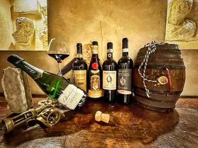 a group of wine bottles and a glass on a table at Residenza San Calisto in Rome