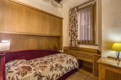 a bedroom with a bed and a window at Residenza San Calisto in Rome