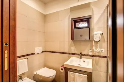 a bathroom with a toilet and a sink at Residenza San Calisto in Rome
