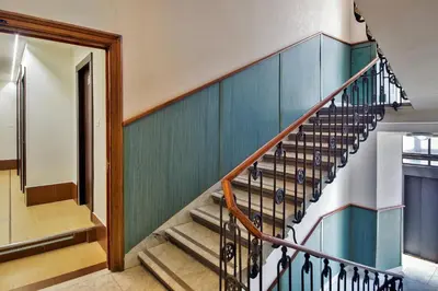 a staircase in a house with blue walls at Hotel Dei Mille in Rome