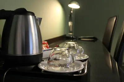 a table with two tea pots and a coffee maker at Locanda degli Antiquari in Rome