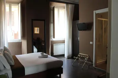 a bedroom with a bed and a television in it at Locanda degli Antiquari in Rome