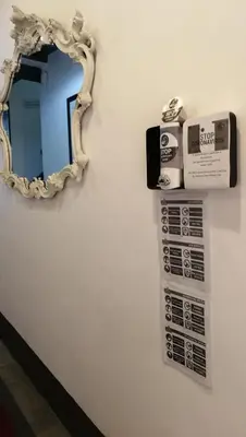 a mirror on a wall next to a bathroom at Locanda degli Antiquari in Rome