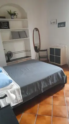 a bedroom with a bed and a chair at Testaccio comodo appartamento in Rome