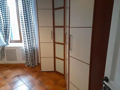 a room with a tall cabinet and a window at Testaccio comodo appartamento in Rome