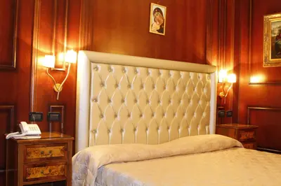 a bedroom with a bed and a telephone in it at Boutique Hotel Trevi in Rome