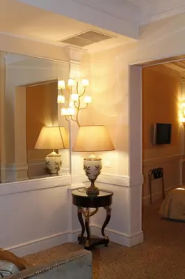 a lamp on a table in a room with a mirror at Boutique Hotel Trevi in Rome