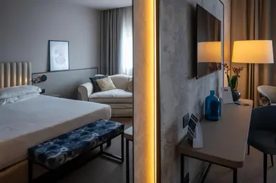 a hotel room with a bed and a desk with a computer at BV Hotel Oly in Rome