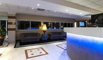 a lobby of a hotel with couches and a bar at BV Hotel Oly in Rome