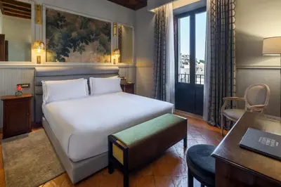 a hotel room with a bed and a desk at Donna Camilla Savelli - VRetreats in Rome