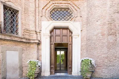 an entrance to a brick building with a door at Donna Camilla Savelli - VRetreats in Rome
