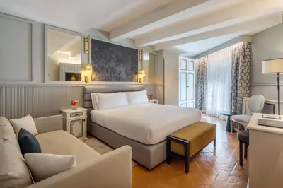 a hotel room with a bed and a couch at Donna Camilla Savelli - VRetreats in Rome